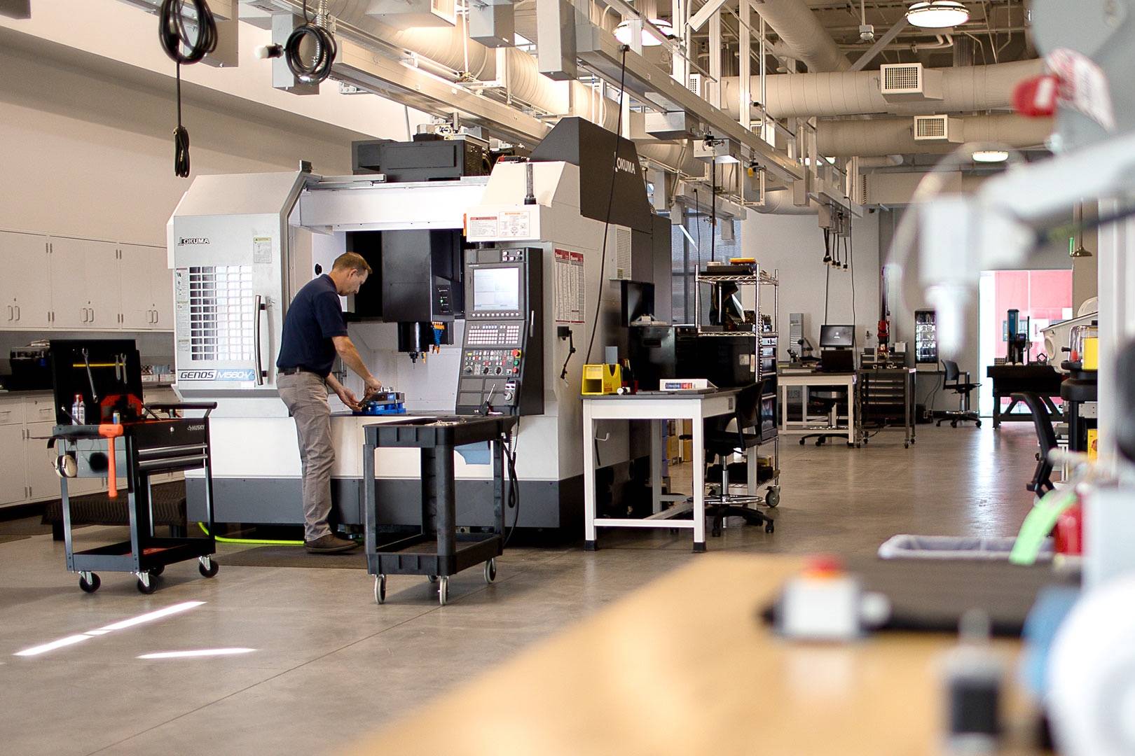 Setting up a part on a CNC machining center in an AES building lab.